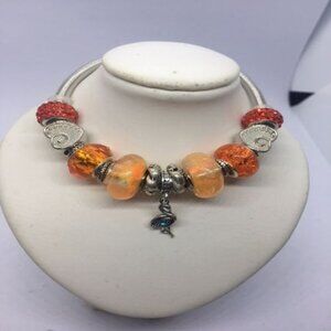 Silver Twist Bracelet with Orange Glow in the Dark Beads and Crystal Bird Charm